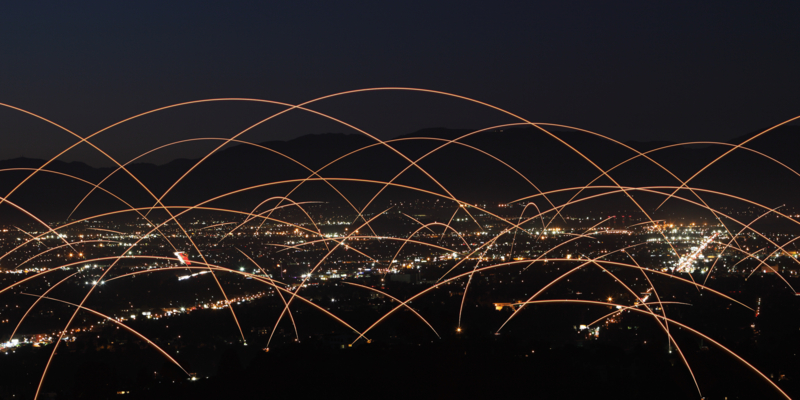 Networks of  communication and fiber-optics over city skyline.