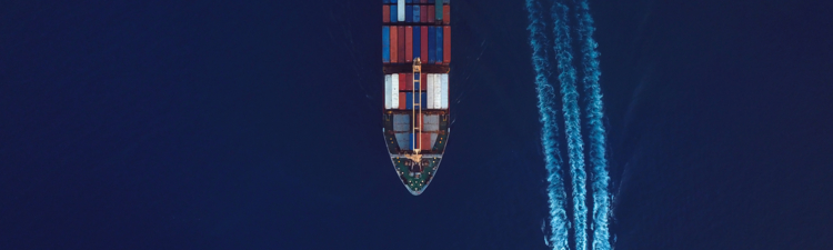 High angle view of an industrial ship surrounded by deep blue waters.