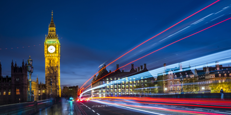Big Ben at night and Westminster bridge with red and blue car light trails