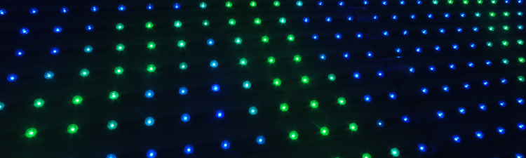 a wall of blue and green pin lights