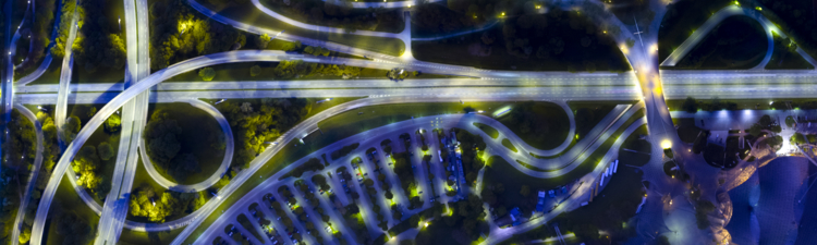 Bird's eye view, aerial view or overhead view of a city at night. Germany, Bavaria, Munich. Highway, streets, parking lot