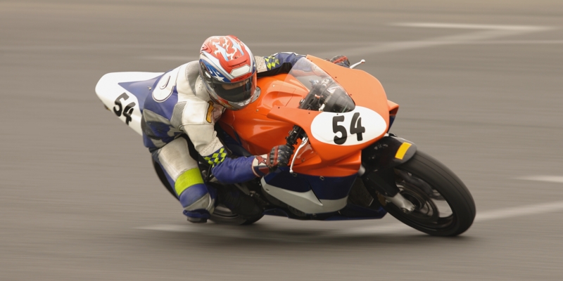 Racing motor bike cornering at speed