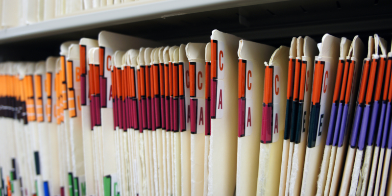 Medical records in file cabinet at doctor's office.
