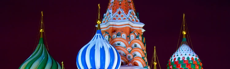 Upper part of  the Saint Basil's Cathedral at the Red Square in Moscow illuminated by streetlight and covered by snow by a winter night. Landscape orientation. 