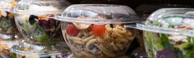 A closeup shot of tasty food in plastic containers in the shop