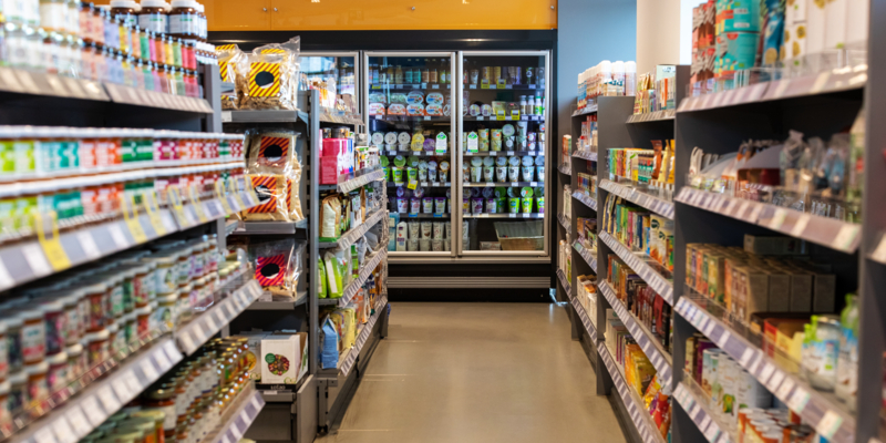 Shot of a supermarket aisles with variety of products on shelves. Grocery store with products in racks.