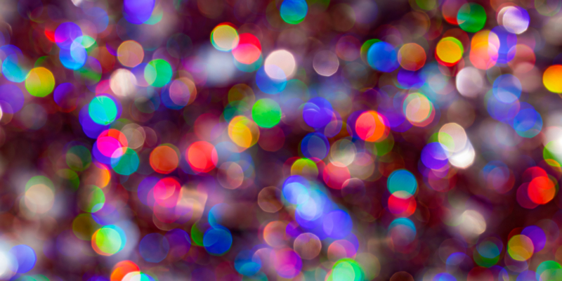 Abstract Christmas glittering backdrop. Background of blur colorful texture bokeh for Festival and New year. Game of color.