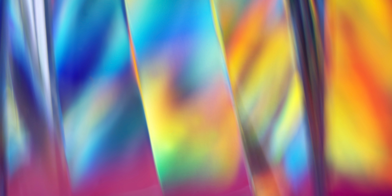 Striped glass surface with holographic color effects, close-up