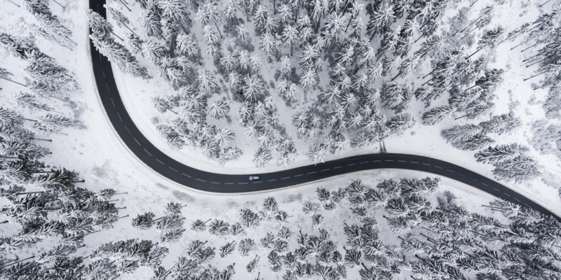 Road through the wintery forest - aerial view
