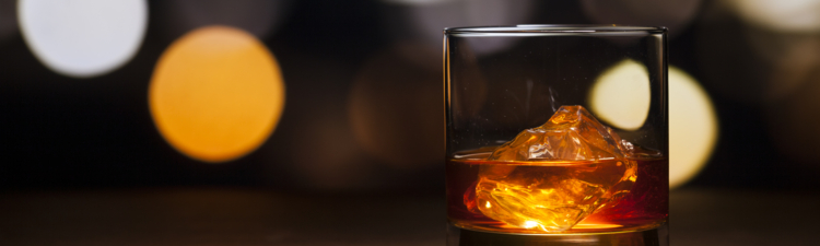 Photography of a glass whisky with ice.