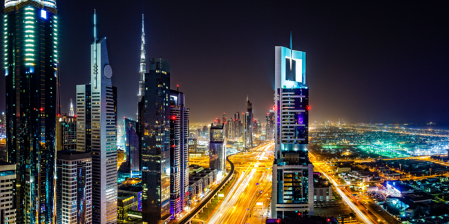 Modern Dubai cityscape along E11 Sheikh Zayed Road highway, Dubai, United Arab Emirates at twilight.