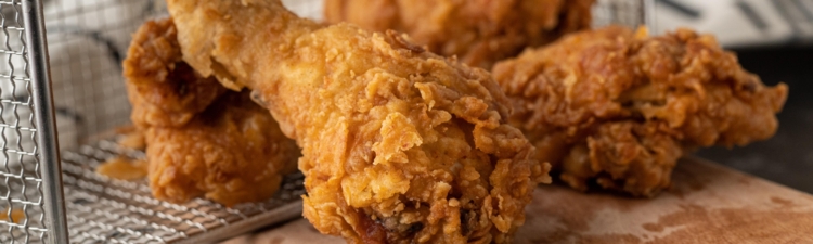 Fried chicken falling out of metal basket